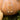 Gold pumpkin-shaped earrings with star and moon charms on a pumpkin background