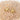 Gold starfish earrings on a sandy surface